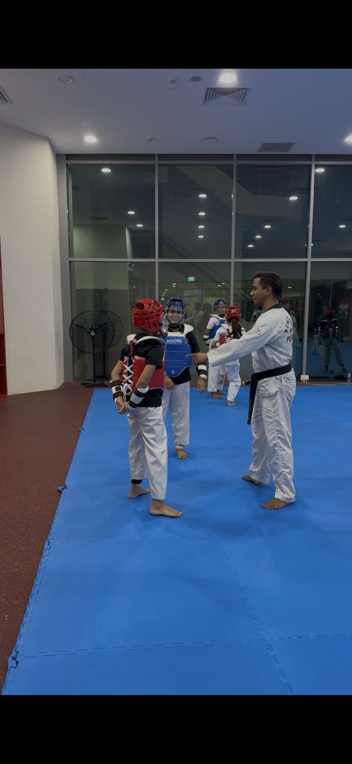 Taekwondo CCA training session in a school hall