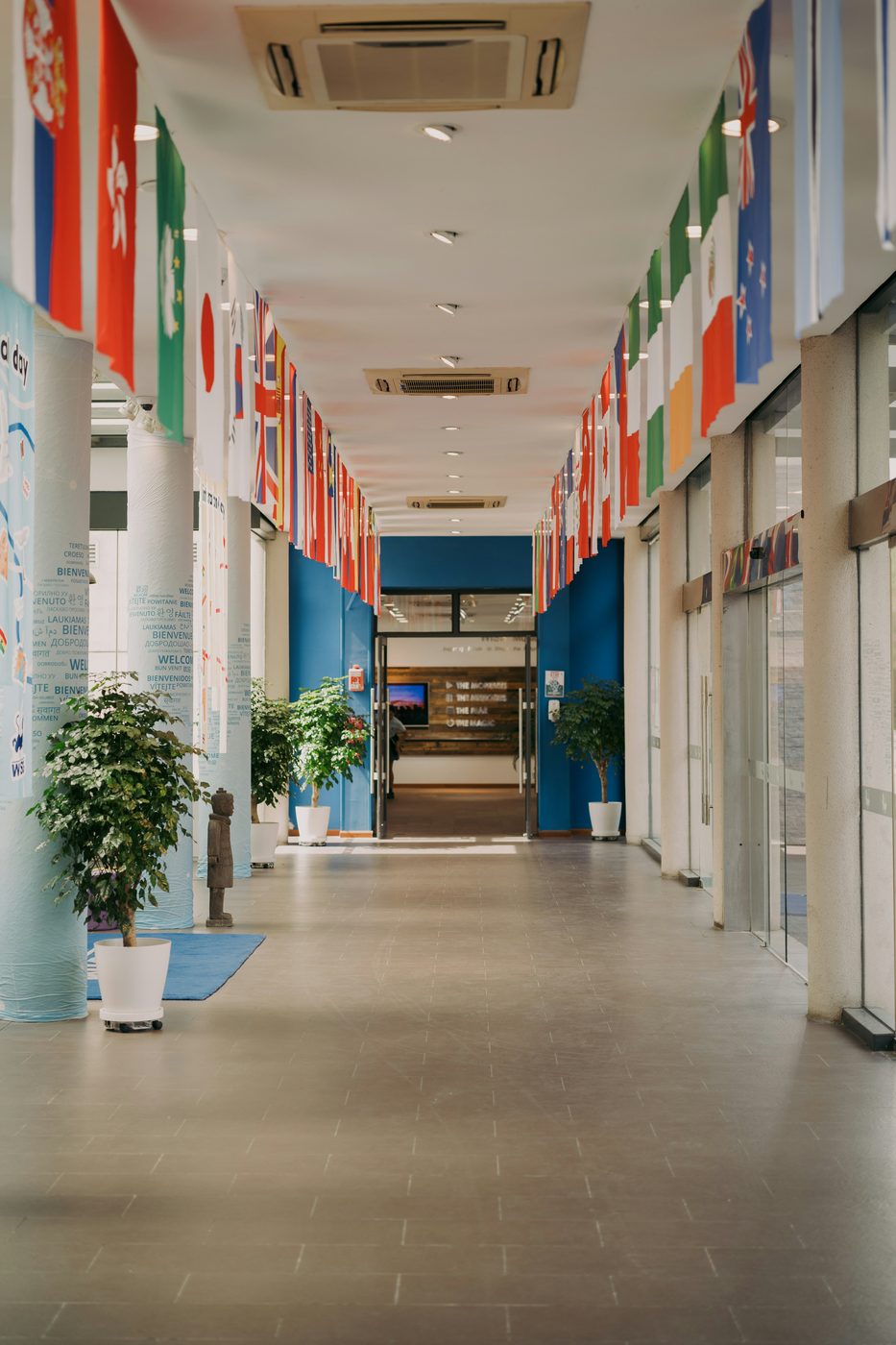 A welcoming corridor lined with national flags at an international school in Singapore
