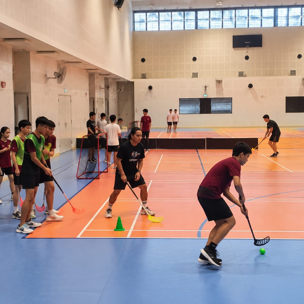 Students playing Floorball during a Momentum Academy programme in Singapore