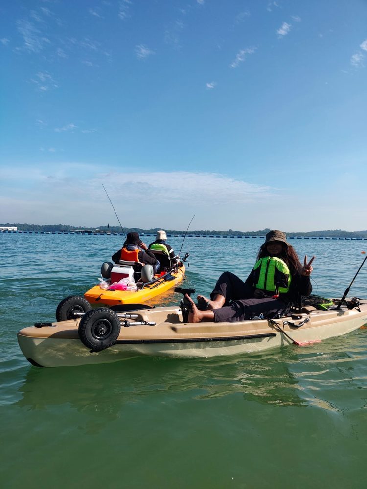 Participants fishing from kayaks at sea during a Kayak Fishing session with Momentum Academy in Singapore