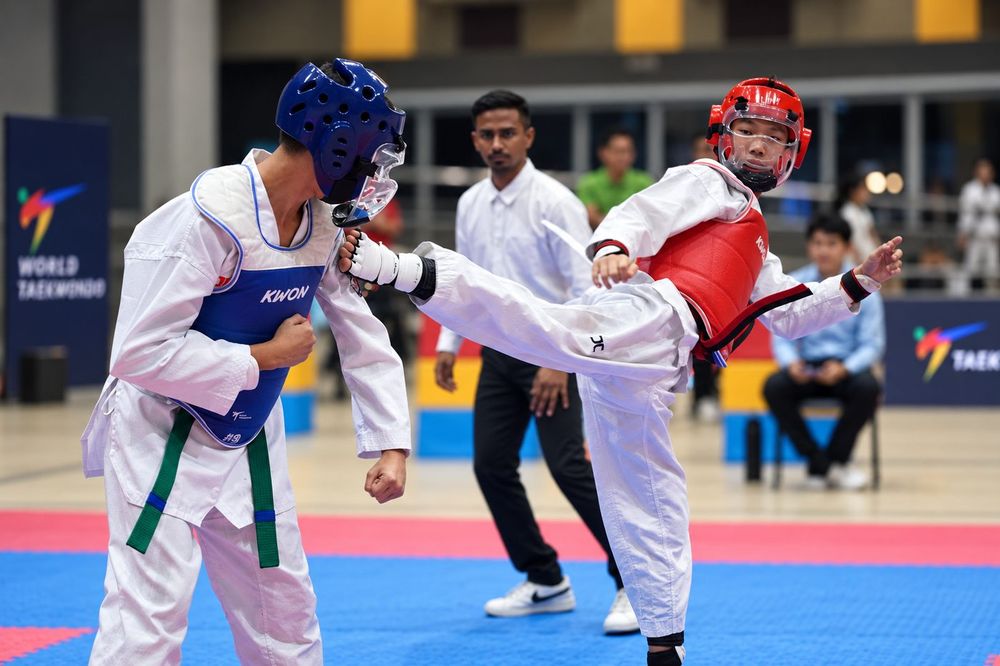 Students practising Taekwondo Sparring (Kyorugi) Clinic techniques with a Momentum Academy coach in Singapore